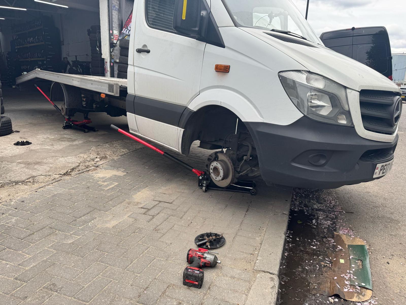 Mobile tyre technician performing 24/7 emergency tyre fitting on location in London